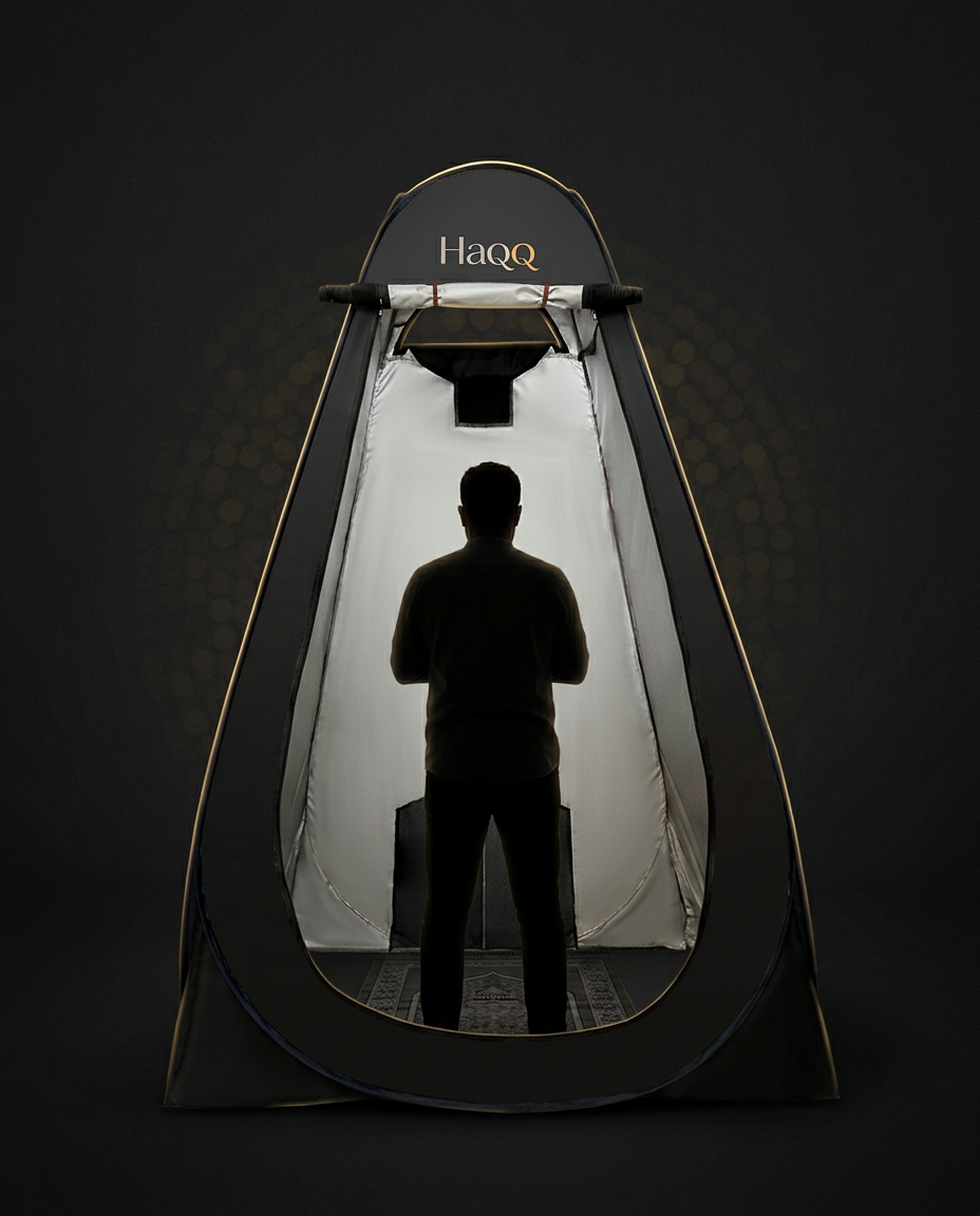 The HaQQ pop-up prayer tent, fully open, with a person standing inside in prayer